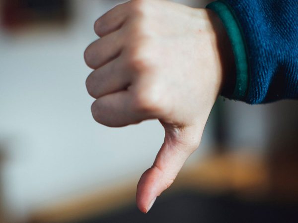 An image of a hand showing the thumbs down symbol